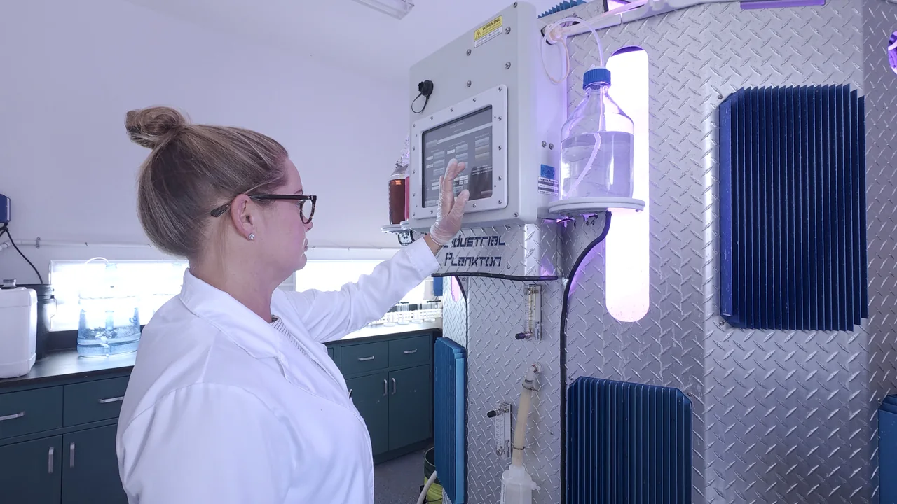 Person operating a laboratory equipment touchscreen